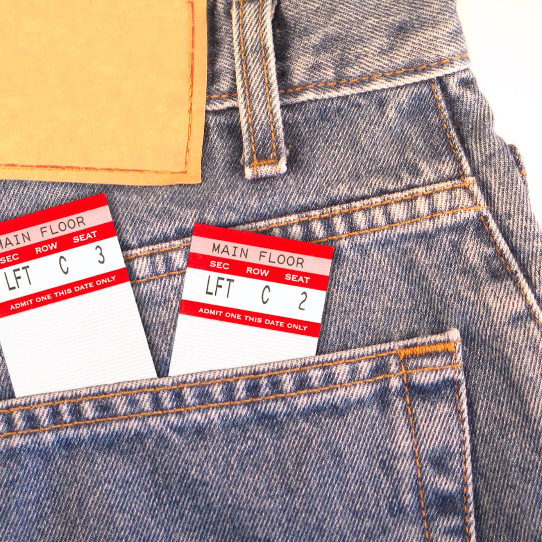 a pair of jeans with concert tickets in the back pocket