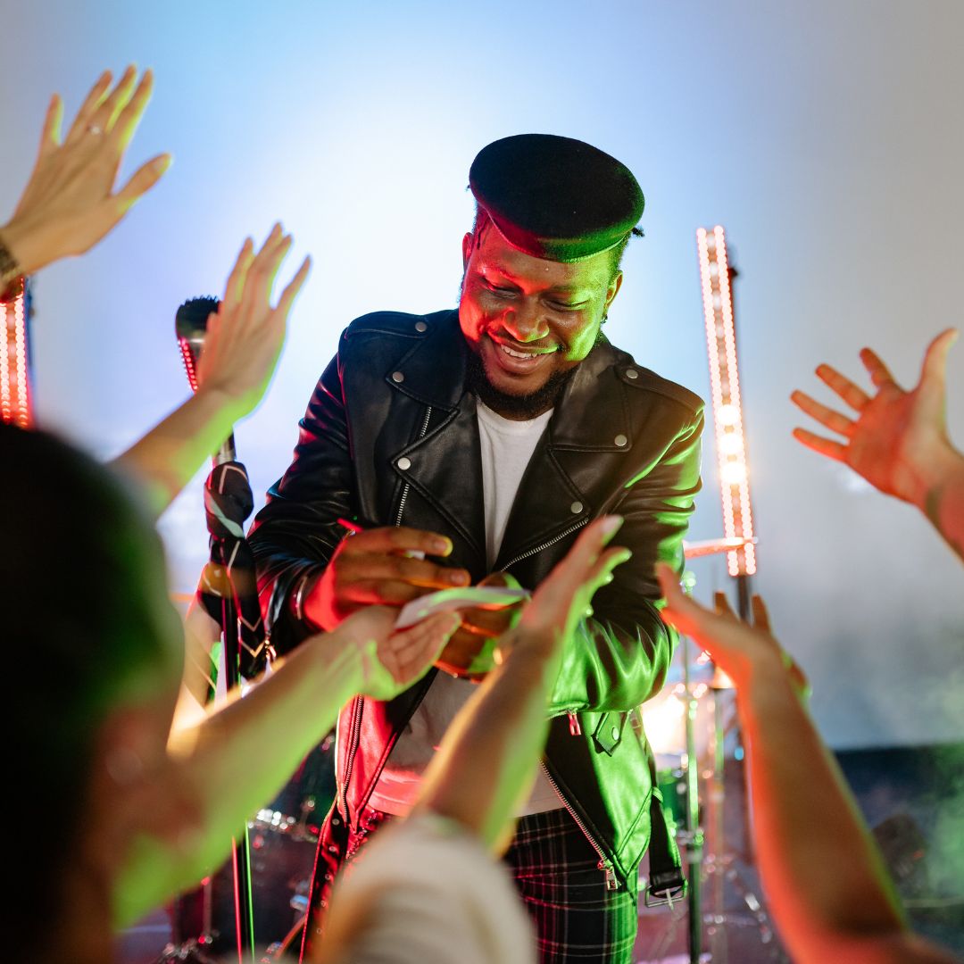 a musician signing autographs at a concert