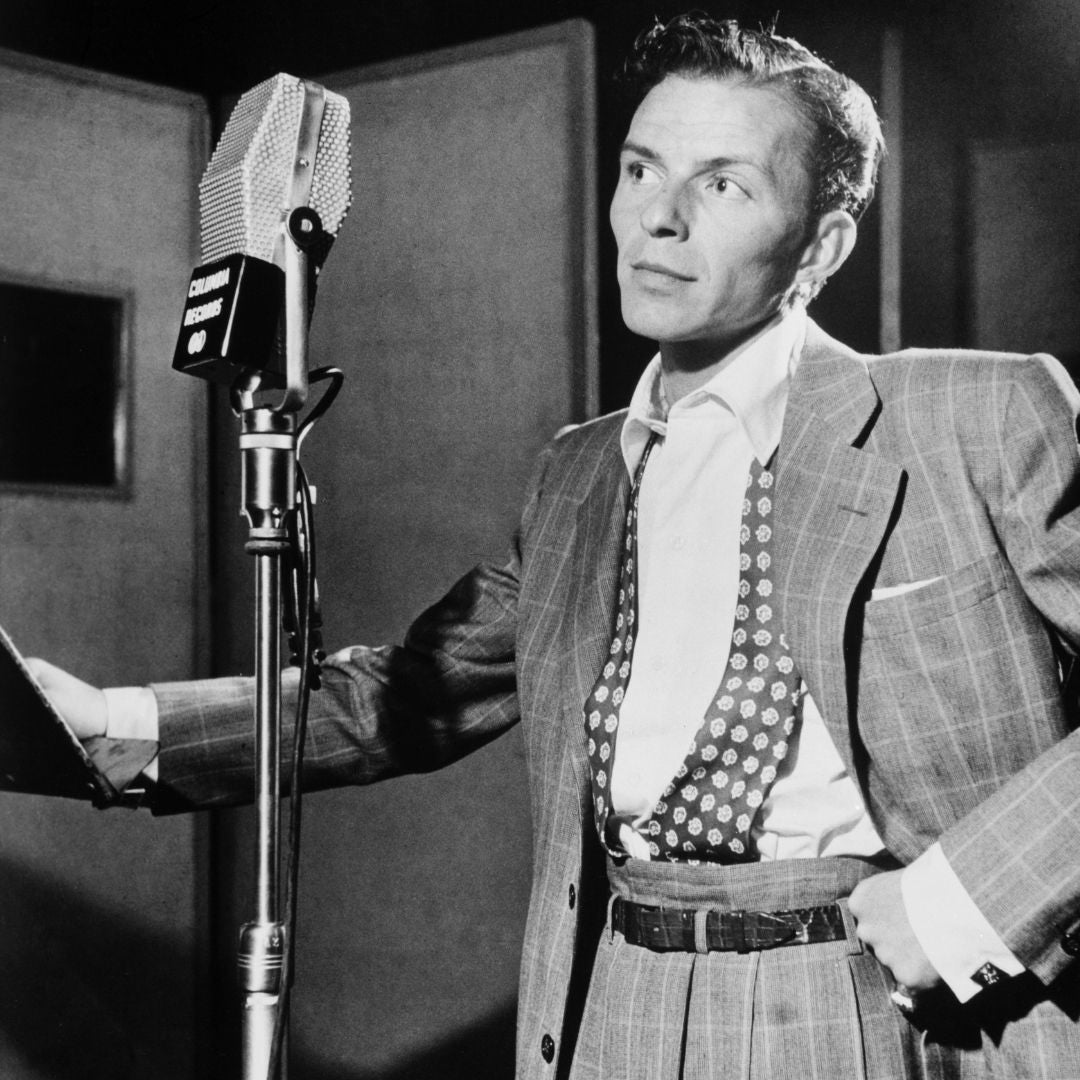 old time singer standing by microphone showing the tradition of this style