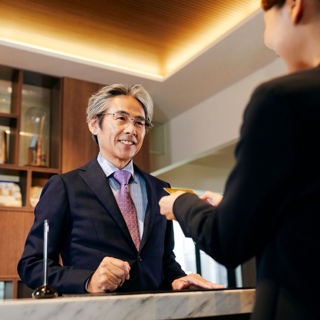 man checking into hotel
