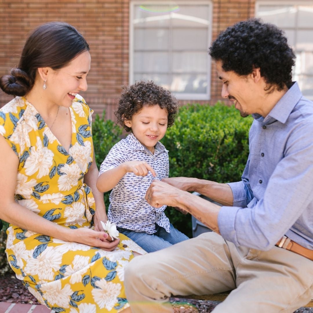 couple sitting with a kid outside event center